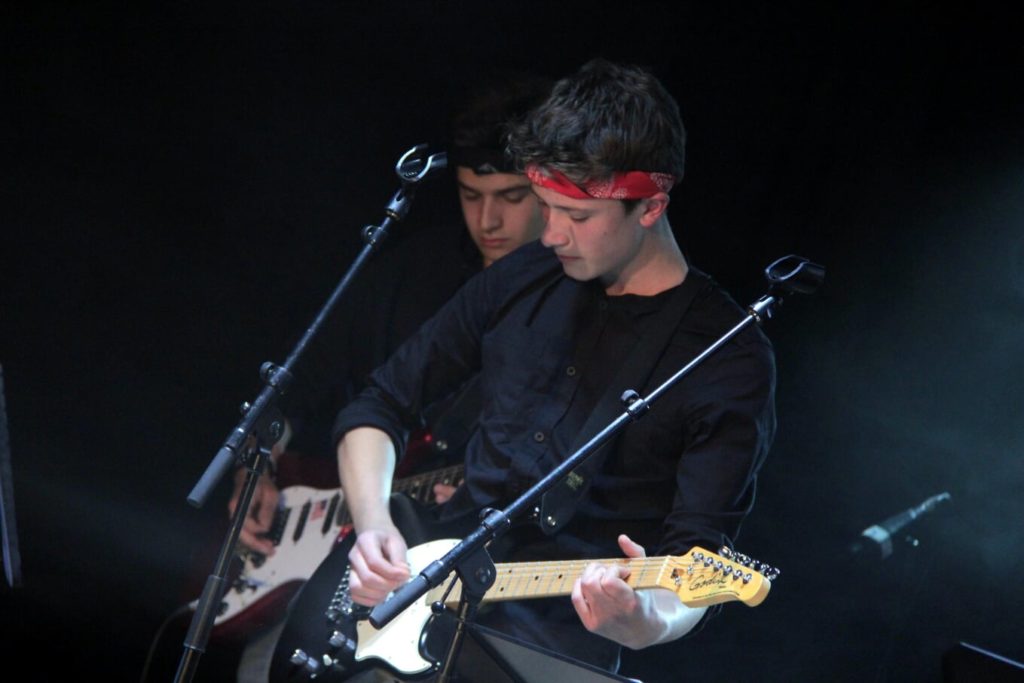 deux guitaristes derrière un micro